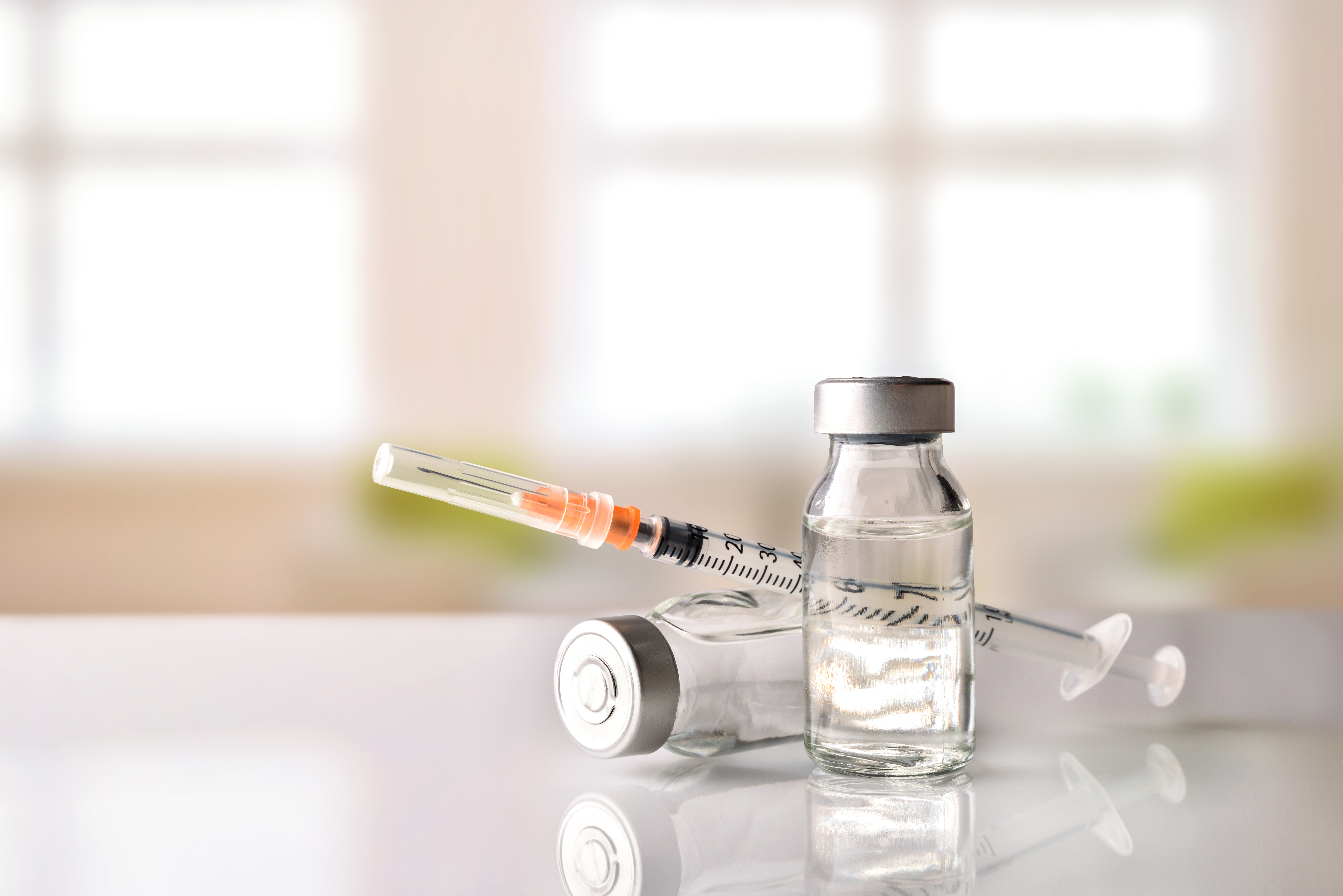 Picture of needle and liquid in two bottles